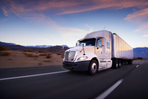 Truck Accident Lawyer Metairie, LA - Truck and highway at sunset - transportation background