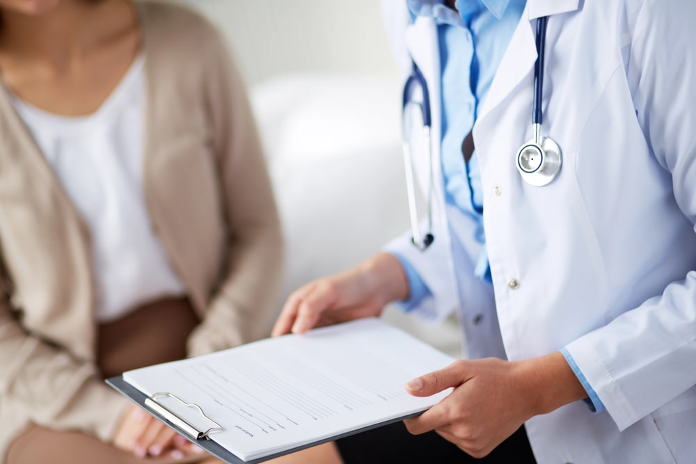 Doctor reviewing patient chart in hospital