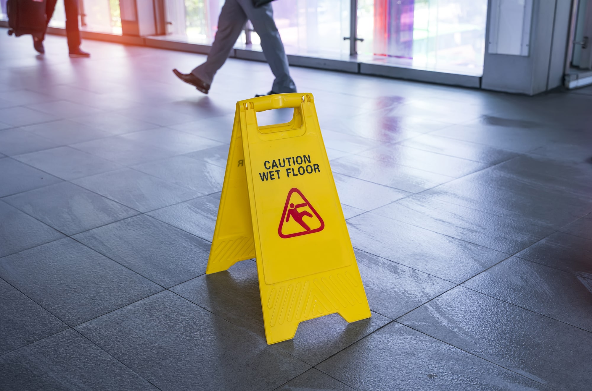 Person tripping on cracked sidewalk edge